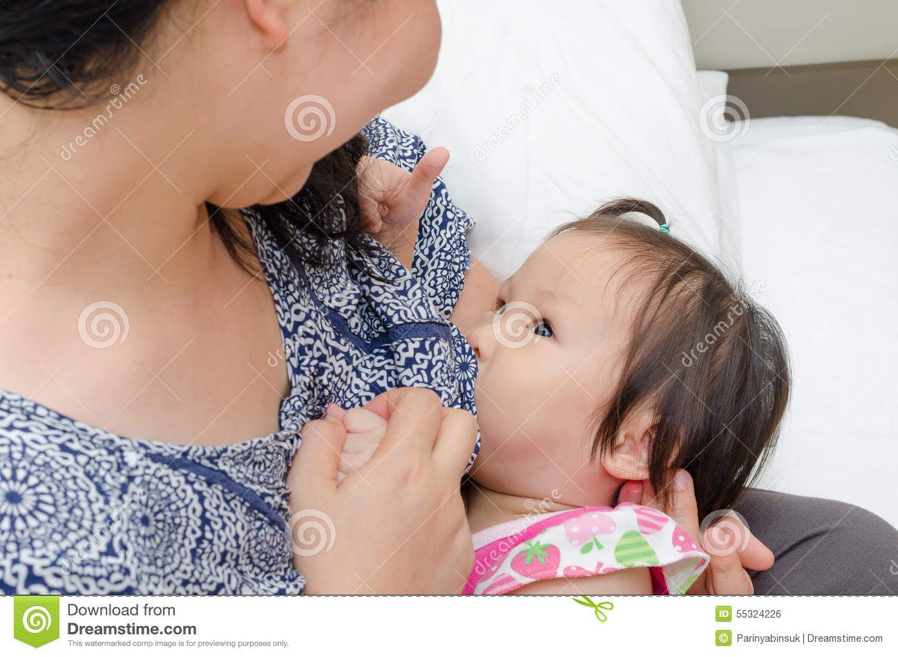 Asian woman breast feeding man